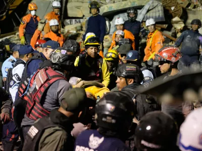 Rescue workers search through the rubble of a collapsed building after earthquake in Caracas, Venezuela, Wednesday, June 24, 2026. (AP Photo/Ariana Cubillos)