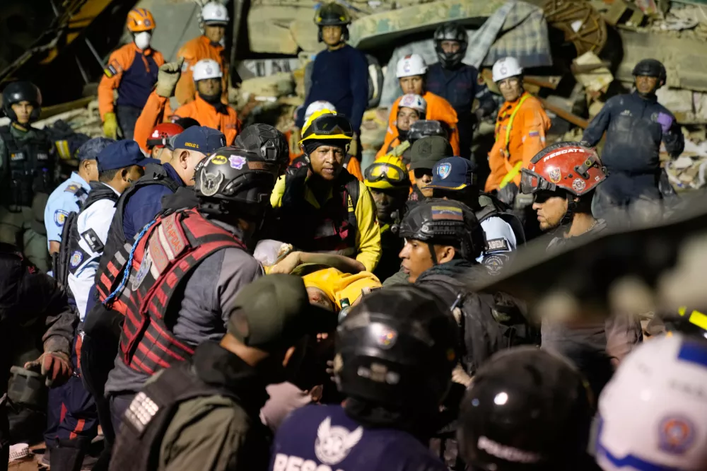 Rescue workers search through the rubble of a collapsed building after earthquake in Caracas, Venezuela, Wednesday, June 24, 2026. (AP Photo/Ariana Cubillos)