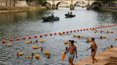 People swim in the River Seine at the Bras Marie site, opened to swimmers marking the first public bathing session in the capital's historic waterway, in Paris, France, July 5, 2025. REUTERS/Abdul Saboor