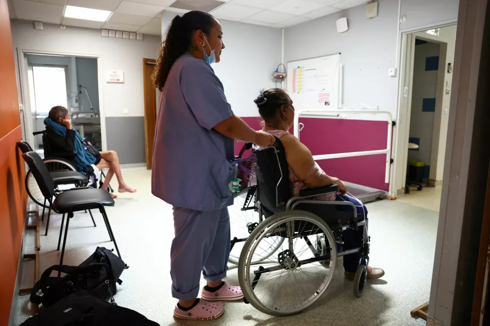 A nurse assists a patient at the Manhes Private Hospital in Fleury-Merogis near Paris during a heatwave affecting a majority of the country, France, June 25, 2026. REUTERS/Abdul Saboor