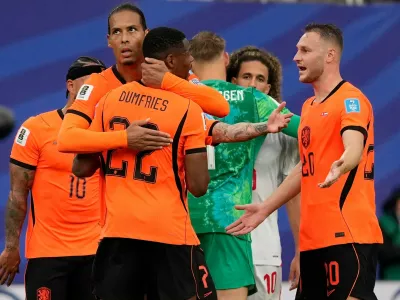Netherlands' Virgil van Dijk (4) and Denzel Dumfries (22) celebrate a win during the World Cup Group F soccer match between Tunisia and the Netherlands in Kansas City, Mo., Thursday, June 25, 2026. (AP Photo/Charlie Riedel)