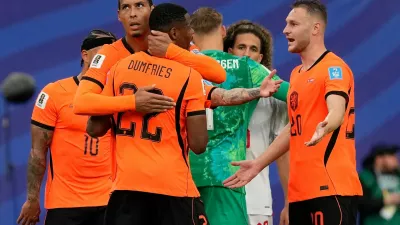 Netherlands' Virgil van Dijk (4) and Denzel Dumfries (22) celebrate a win during the World Cup Group F soccer match between Tunisia and the Netherlands in Kansas City, Mo., Thursday, June 25, 2026. (AP Photo/Charlie Riedel)