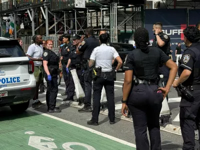 New York Police Department officers gather after alleged gunfire was heard in Times Square, in New York City, U.S., June 18, 2026. Picture taken with a phone. REUTERS/Andrew Hofstetter