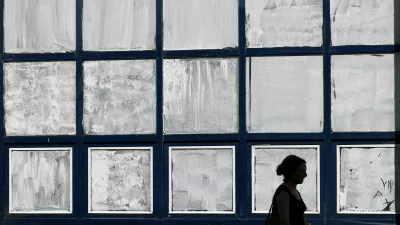 A woman walks past the public school Marie-Anne du Boccage with windows coated in Blanc de Meudon, a chalk-based powder applied by parents to protect their children from the heat in Nantes, during a heatwave affecting a majority of the country, France, June 25, 2026. REUTERS/Stephane Mahe   TPX IMAGES OF THE DAY