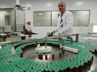 A laboratory technician is seen at a Sanofi-Pasteur production plant manufacturing Panenza, a vaccine for the H1N1 flu virus, in Val-de-Reuil, western Paris, Monday, Oct. 19, 2009. France will begin vaccinating key medical workers against swine flu on Tuesday, Oct. 20, 2009. (AP Photo/Jacques Brinon)