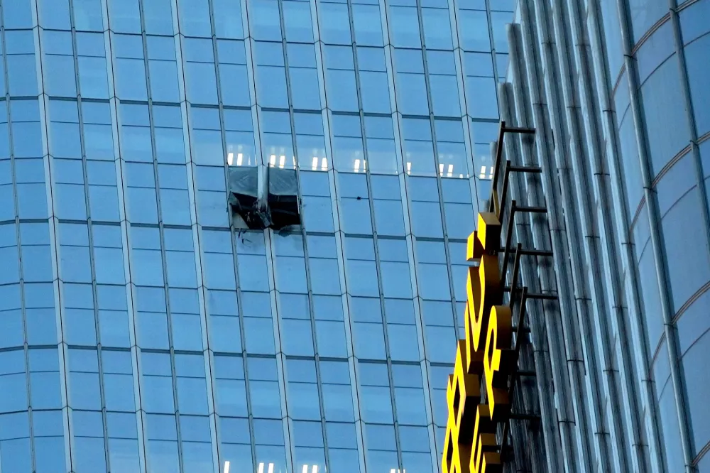 The surface of the Citic Tower also known as Zun Tower is damaged in Beijing, Cina, Friday, June 26, 2026. (AP Photo/Han Guan Ng) Correction: source of the damage removed as it is unknown and name of the building added