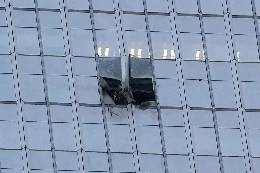 The surface of the Citic Tower also known as Zun Tower is damaged in Beijing, Cina, Friday, June 26, 2026. (AP Photo/Han Guan Ng) Correction: source of the damage removed as it is unknown and name of the building added