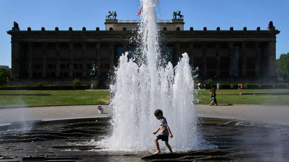 A child cool off in a fountain in front of Berlin Cathedral as temperature rise in Berlin, Germany, during a summer heat wave, Friday, June 24, 2026. (AP Photo/Ebrahim Noroozi)