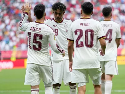 Spain's Lamine Yamal, second from left, congrats Alex Baena (15) after scored the opening goal during the World Cup Group H soccer match between Uruguay and Spain in Zapopan, near Guadalajara, Mexico, Friday, June 26, 2026. (AP Photo/Natacha Pisarenko)