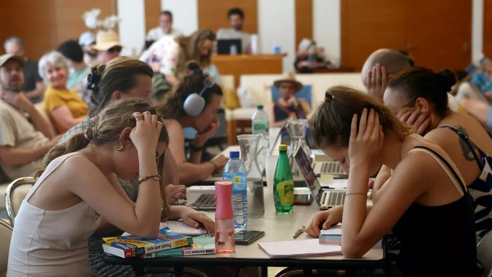 Middle school students work to prepare the "brevet des colleges" (middle school diploma) inside an air-conditioned room open to the public inside the 17th district city hall as temperatures rise in Paris, during a heatwave affecting a majority of the country, in France, June 25, 2026. REUTERS/Alice Sacco