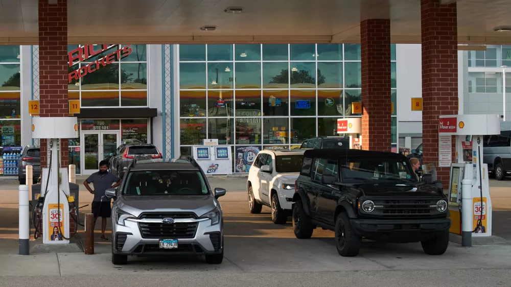 Customer fill up their vehicle's tank at a gas station in Buffalo Grove, Thursday, June 25, 2026. (AP Photo/Nam Y. Huh)