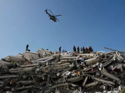 Rescue workers search through the rubble three days after earthquakes struck Catia la Mar, Venezuela, Saturday, June 27, 2026. (AP Photo/Fernando Vergara)