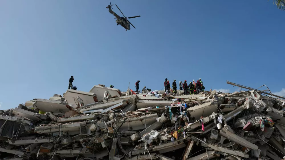 Rescue workers search through the rubble three days after earthquakes struck Catia la Mar, Venezuela, Saturday, June 27, 2026. (AP Photo/Fernando Vergara)
