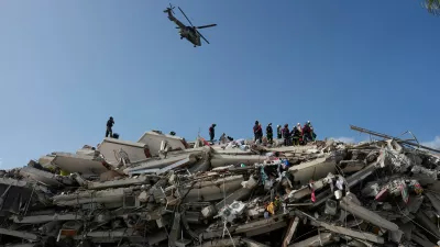 Rescue workers search through the rubble three days after earthquakes struck Catia la Mar, Venezuela, Saturday, June 27, 2026. (AP Photo/Fernando Vergara)