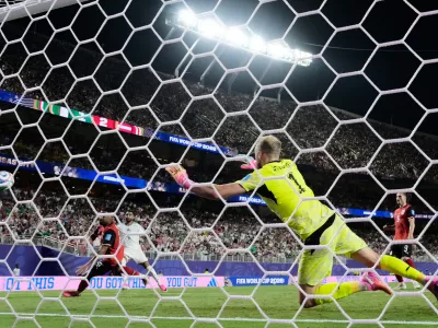 Algeria's Riyad Mahrez (7) scores their second goal past Austria goalkeeper Alexander Schlager (1) during the World Cup Group L soccer match between Croatia and Ghana in Philadelphia, Saturday, June 27, 2026. (AP Photo/Charlie Riedel)
