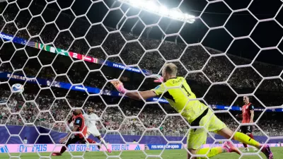 Algeria's Riyad Mahrez (7) scores their second goal past Austria goalkeeper Alexander Schlager (1) during the World Cup Group L soccer match between Croatia and Ghana in Philadelphia, Saturday, June 27, 2026. (AP Photo/Charlie Riedel)