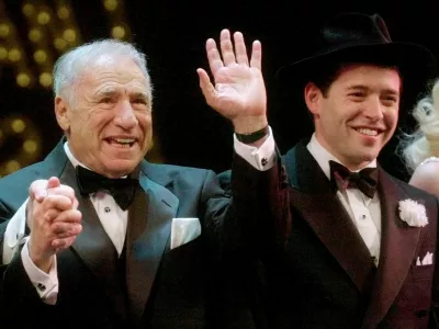 FILE - Mel Brooks, left, and Matthew Broderick react to a standing ovation at opening night of "The Producers" in New York on April 19, 2001. (AP Photo/Mark Lennihan, File)
