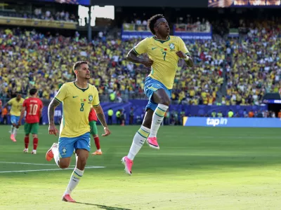 Brazil's Vinicius Junior (7) celebrates with teammate Bruno Guimaraes (8) after scoring during the World Cup Group C soccer match against Morocco in East Rutherford, N.J., near New York, Saturday, June 13, 2026. (AP Photo/Matt Slocum)