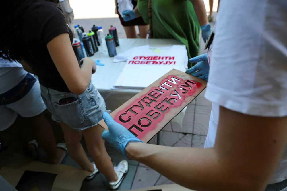 A volunteer carries a stencil with the slogan "Students are winning" to spray onto T-shirts as students gather during a protest as part of a nationwide anti-government movement triggered by the deadly collapse of the Novi Sad railway station canopy in November 2024, following Serbian President Aleksandar Vucic's resignation announcement, in Kraljevo, Serbia, June 28, 2026. REUTERS/Djordje Kojadinovic