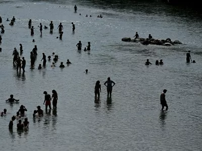 People enjoy the cool waters of the Isar during a heatwave in Munich, Germany, June 28, 2026. REUTERS/Angelika Warmuth