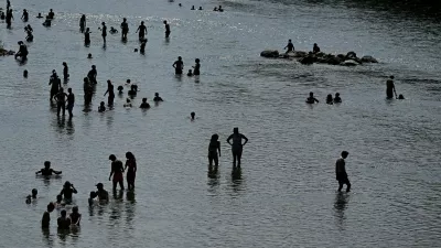 People enjoy the cool waters of the Isar during a heatwave in Munich, Germany, June 28, 2026. REUTERS/Angelika Warmuth