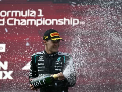 Mercedes driver George Russell of Britain celebrates on the podium after winning the Austrian F1 Grand Prix, in Spielberg, Austria, Sunday, June 28, 2026. (AP Photo/Denes Erdos)