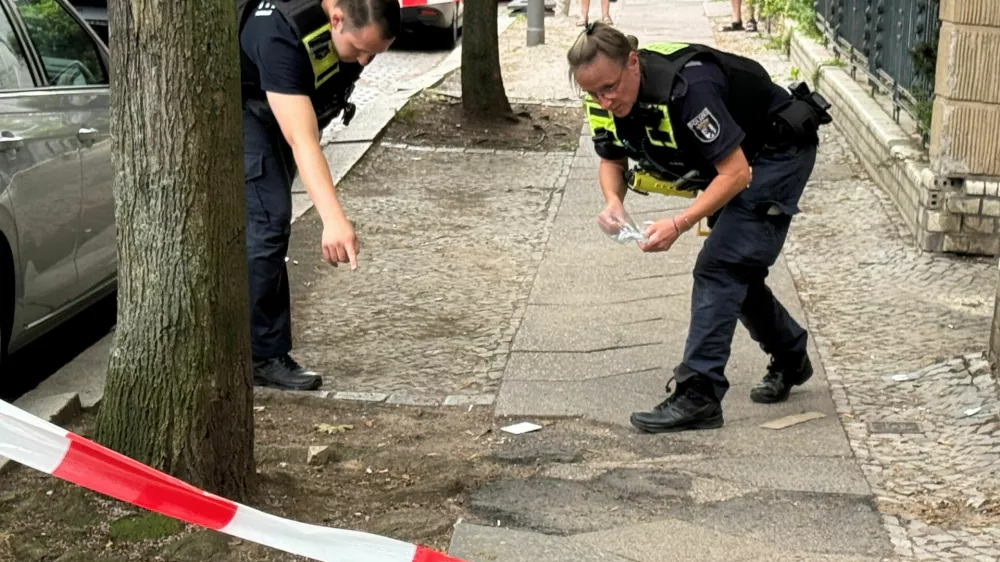 Police officers secure evidence at the scene of a shooting at Berlin's Steglitz district, Germany, June 27, 2026. Picture taken with a phone. REUTERS/Fabrizio Bensch
