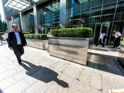 London, UK - June 26, 2018: Entrance exterior to JP Morgan office financial bank building in Canary Wharf Docklands, architecture during morning rush hour, business man walking