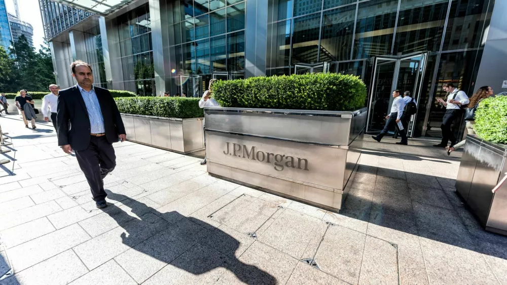 London, UK - June 26, 2018: Entrance exterior to JP Morgan office financial bank building in Canary Wharf Docklands, architecture during morning rush hour, business man walking