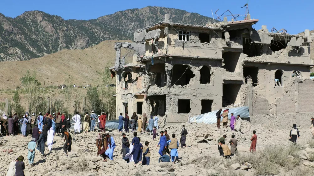 Residents and Taliban members gather near a destroyed building following an airstrike carried out by Pakistan's security forces, in Samkani District, Paktia Province, Afghanistan, June 29, 2026. REUTERS/Stringer