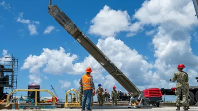NAVAL BASE GUAM (May 6, 2025) – Sailors assigned to Navy Munitions Command Pacific, East Asia Division, Unit Guam load UGM-109 Tomahawk missiles onto the Los Angeles-class fast-attack submarine USS Jefferson City (SSN 759), May 6, 2025. Assigned to Commander, Submarine Squadron 15 at Polaris Point, Naval Base Guam, Jefferson City is one of five fast-attack submarines forward-deployed in the Pacific. Renowned for their unparalleled speed, endurance, stealth, and mobility, fast-attack submarines serve as the backbone of the Navy's submarine force, ensuring readiness and agility in safeguarding maritime interests around the world. (U.S. Navy photo by Lt. James Caliva),Image: 1017624832, License: Rights-managed, Restrictions:, Model Release: no