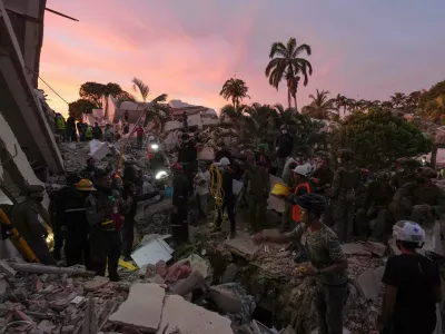 Rescuers search a building where for earthquake survivors in La Guaira, Venezuela, Sunday, June 28, 2026. (AP Photo/Matias Delacroix)
