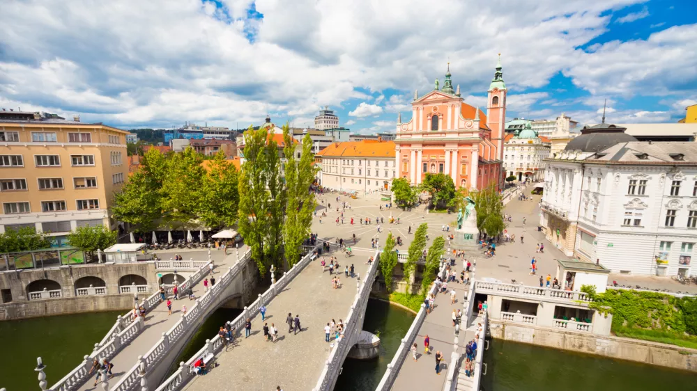 Romantic Ljubljana city center: river Ljubljanica, Triple Bridge (Tromostovje), Preseren square and Franciscan Church of the Annunciation; Ljubljana, Slovenia, Europe.