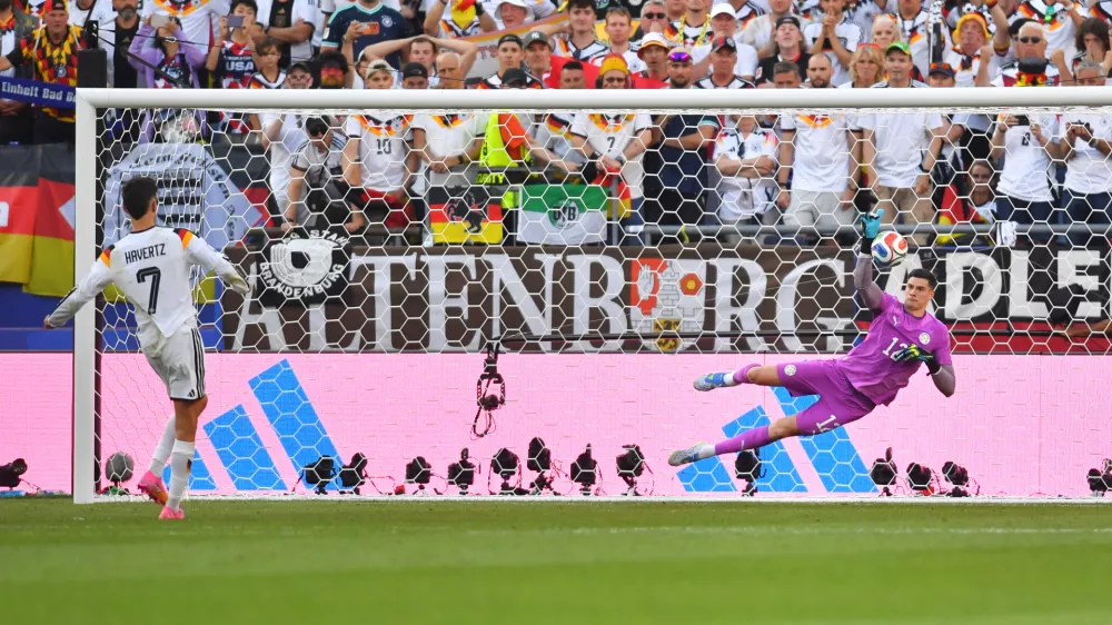 Paraguay goalkeeper Orlando Gill (12) blocks a shot by Germany's Kai Havertz (7) in a shootout during the World Cup round of 32 soccer match in Foxborough, Mass., near Boston, Monday, June 29, 2026. (AP Photo/Steven Senne)