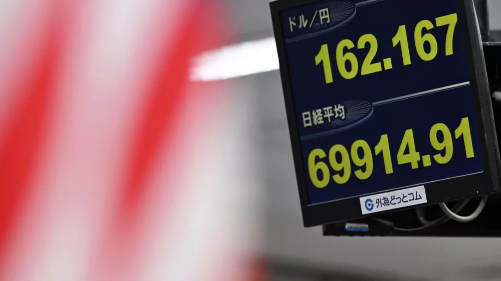 An electronic board shows Japan's benchmark Nikkei 225 index, bottom, and exchange rate of the Japanese yen against the U.S. dollar in Tokyo Tuesday, June 30, 2026. (Kenichiro Kojima/Kyodo News via AP)