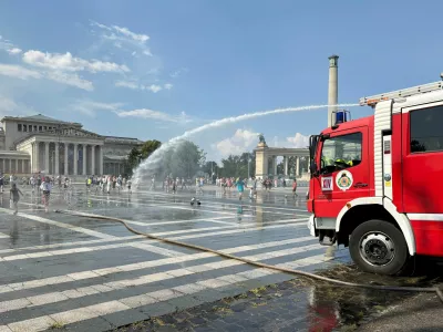 Firefighters use water cannons to spray residents at Heroes Square to help them cool off during a severe heatwave in Budapest, Hungary, June 30, 2026. Picture taken with a mobile phone. REUTERS/Krisztina Fenyo   TPX IMAGES OF THE DAY