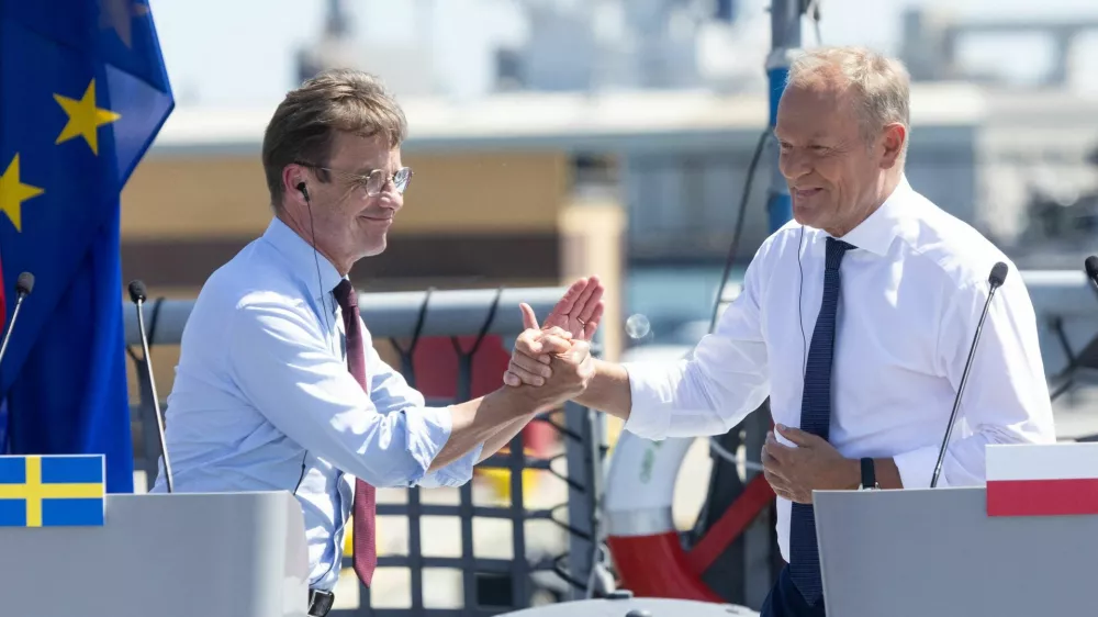 Swedish Prime Minister Ulf Kristersson and Polish Prime Minister Donald Tusk hold hands after the ceremony of signing the agreement for Poland to purchase three Swedish-made A26 blekinge-class submarines, during an official ceremony on board the Polish frigate ORP General Tadeusz Kosciuszko at the naval base in Gdynia, Poland, June 29, 2026. REUTERS/Lukasz Glowala