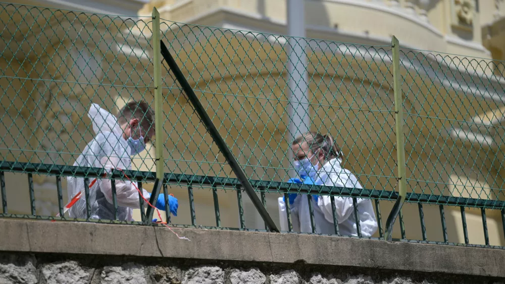 Investigators examine the scene at the residential building where an explosive device seriously injured three people a day earlier in Monaco, Tuesday, June 30, 2026. (AP Photo/Philippe Magoni)