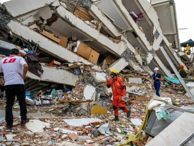 Volunteers and a Mexican rescuer help to find survivors in a collapsed building in Caraballeda, La Guaira state, Venezuela, on June 30, 2026, following the June 24 twin earthquakes. MIGUEL MEDINA/Pool via REUTERS