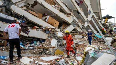 Volunteers and a Mexican rescuer help to find survivors in a collapsed building in Caraballeda, La Guaira state, Venezuela, on June 30, 2026, following the June 24 twin earthquakes. MIGUEL MEDINA/Pool via REUTERS