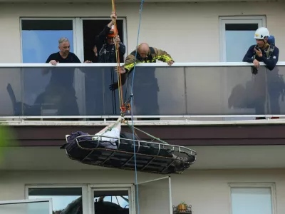 Rescuers evacuate a person at the site of a fire in an housing building in Antwerp, Belgium, July 1, 2026. REUTERS/Yves Herman