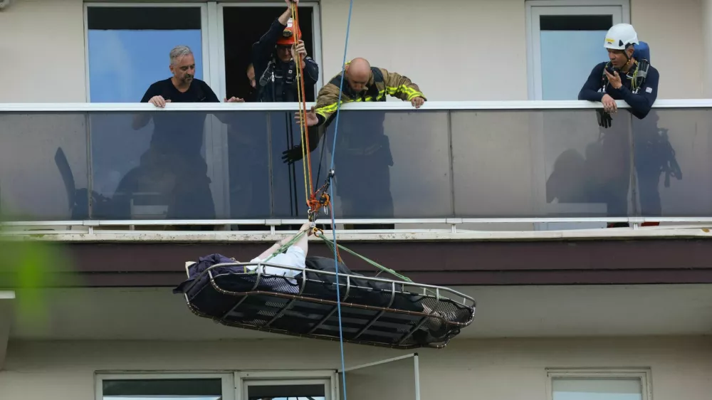 Rescuers evacuate a person at the site of a fire in an housing building in Antwerp, Belgium, July 1, 2026. REUTERS/Yves Herman