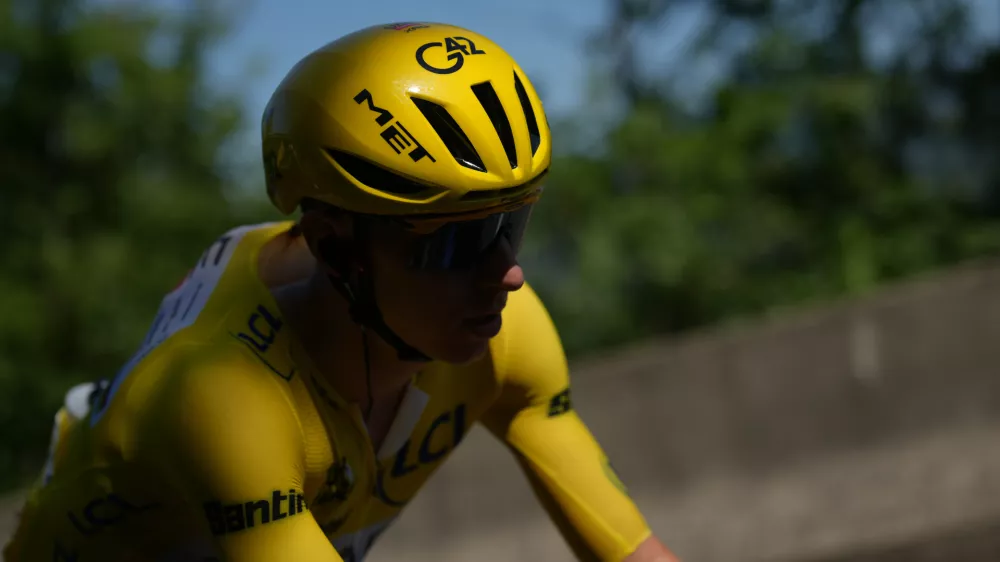 Slovenia's Tadej Pogacar, wearing the overall leader's yellow jersey, rides in the pack, during the fourth stage of the Tour de France cycling race over 181.9 kilometers (112.4 miles) with start in Carcassonne and finish in Foix, France, Tuesday, July 7, 2026. (AP Photo/Thibault Camus)