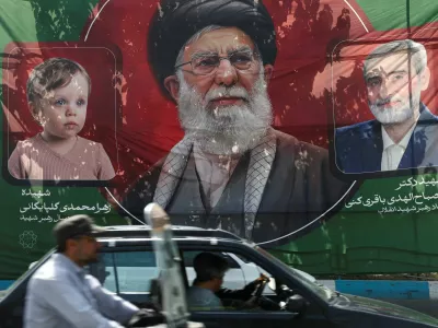 People drive past a banner with a picture of Iran's late Supreme Leader Ayatollah Ali Khamenei, ahead of his farewell ceremony, in Tehran, Iran, July 1, 2026. Majid Asgaripour/WANA (West Asia News Agency) via REUTERS ATTENTION EDITORS - THIS PICTURE WAS PROVIDED BY A THIRD PARTY. ISRAEL OUT. NO COMMERCIAL OR EDITORIAL SALES IN ISRAEL. NO ACCESS FOR ISRAELI MEDIA. NO USE BBC PERSIAN. NO USE VOA PERSIAN. NO USE MANOTO. NO USE IRAN INTERNATIONAL. NO USE RADIO FARDA. DIGITAL: NO USE BBC PERSIAN. NO USE VOA PERSIAN. NO USE MANOTO. NO USE IRAN INTERNATIONAL. NO USE RADIO FARDA.