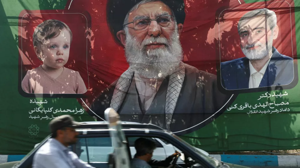 People drive past a banner with a picture of Iran's late Supreme Leader Ayatollah Ali Khamenei, ahead of his farewell ceremony, in Tehran, Iran, July 1, 2026. Majid Asgaripour/WANA (West Asia News Agency) via REUTERS ATTENTION EDITORS - THIS PICTURE WAS PROVIDED BY A THIRD PARTY. ISRAEL OUT. NO COMMERCIAL OR EDITORIAL SALES IN ISRAEL. NO ACCESS FOR ISRAELI MEDIA. NO USE BBC PERSIAN. NO USE VOA PERSIAN. NO USE MANOTO. NO USE IRAN INTERNATIONAL. NO USE RADIO FARDA. DIGITAL: NO USE BBC PERSIAN. NO USE VOA PERSIAN. NO USE MANOTO. NO USE IRAN INTERNATIONAL. NO USE RADIO FARDA.