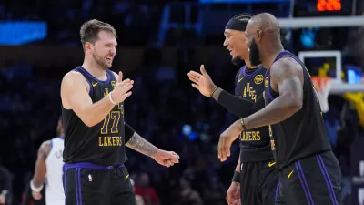 Los Angeles Lakers guard Luka Doncic, from left, center Jaxson Hayes and forward LeBron James (23) react to a play during the second half of an NBA basketball game against the Utah Jazz Tuesday, Nov. 18, 2025, in Los Angeles. (AP Photo/Jae C. Hong)