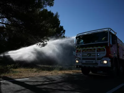 A fire truck sprays water to contain a wildfire in Lancon-Provence near Marseille, France, July 2, 2026. REUTERS/Manon Cruz