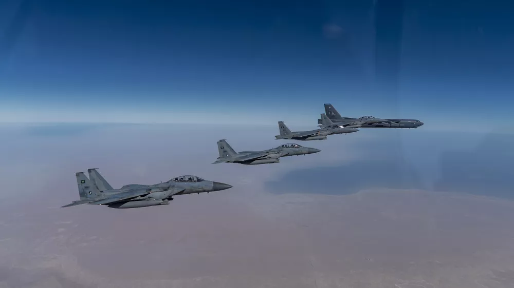 In this Wednesday, Jan. 27, 2021 handout photo, released by the U.S. Air Force, a B-52 bomber from the 2nd Bomb Wing of Barksdale Air Force Base in Louisiana, right, flies with Royal Saudi Air Force F-15s during a mission in the Middle East. The U.S. military said Wednesday it again flew a B-52 bomber over the Middle East "to deter potential aggression" amid tensions with Iran. (U.S. Air Force/Senior Airman Roslyn Ward, via AP)