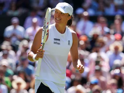Iga Swiatek of Poland celebrates winning the second round women's singles match against Karolina Pliskova of the Czech Republic at the Wimbledon Tennis Championships in London, Thursday, July 2, 2026.(AP Photo/Kirsty Wigglesworth)