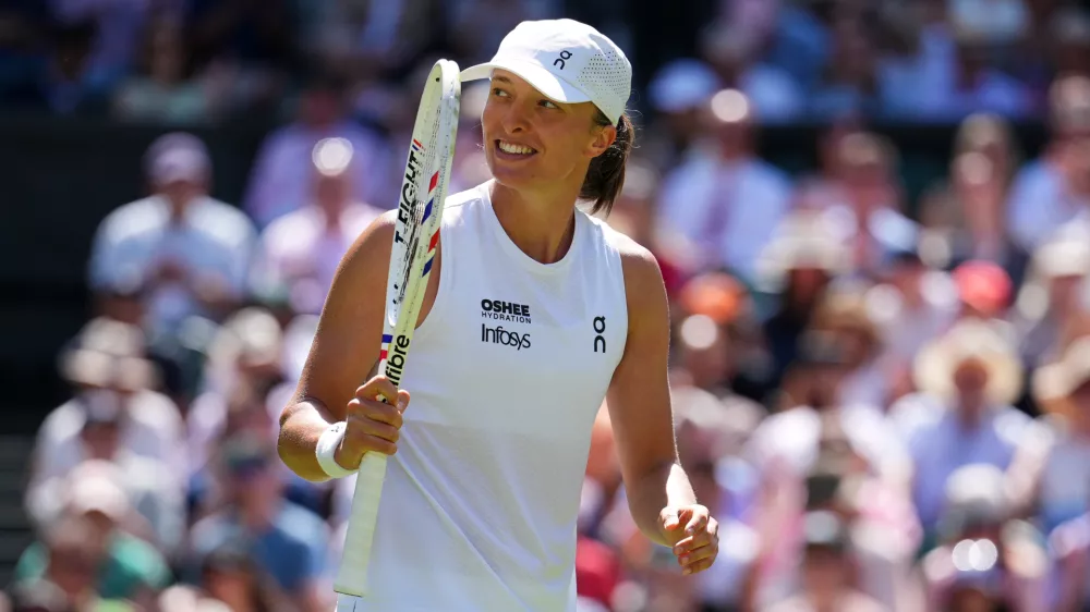 Iga Swiatek of Poland celebrates winning the second round women's singles match against Karolina Pliskova of the Czech Republic at the Wimbledon Tennis Championships in London, Thursday, July 2, 2026.(AP Photo/Kirsty Wigglesworth)